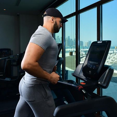 Mina Hotel And Residences By The Torch Doha Exteriör bild A man exercising on a treadmill