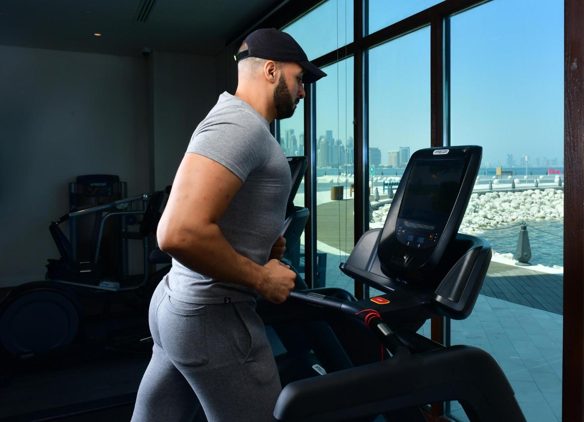 Mina Hotel And Residences By The Torch Doha Exteriör bild A man exercising on a treadmill