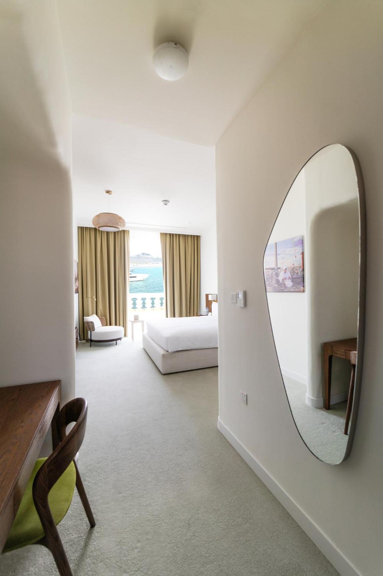 Mina Hotel And Residences By The Torch Doha Exteriör bild A bedroom at the hotel